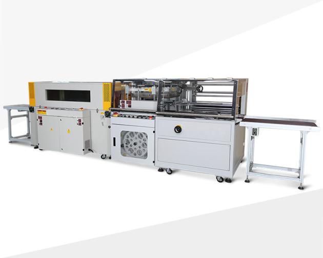 Shrink wrapping machine